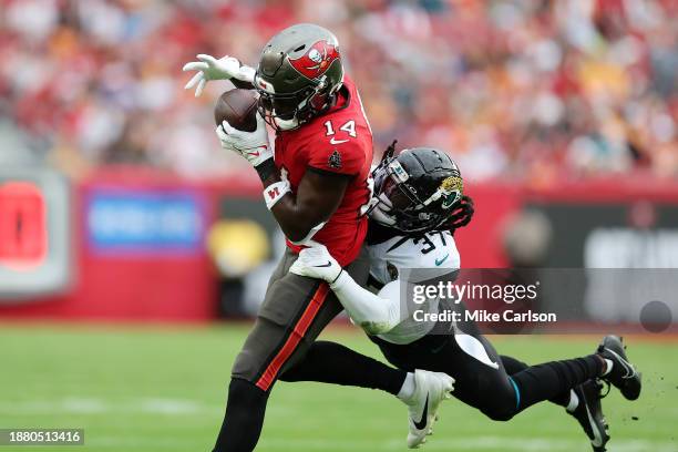 Chris Godwin of the Tampa Bay Buccaneers is tackled by Tre Herndon of the Jacksonville Jaguars during the first quarter at Raymond James Stadium on...