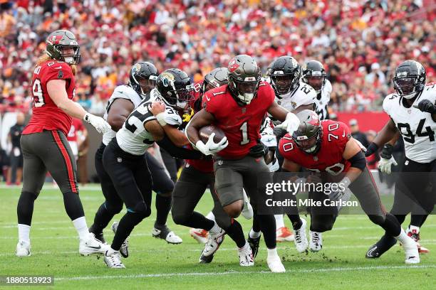 Rachaad White of the Tampa Bay Buccaneers runs the ball against the Jacksonville Jaguars during the first quarter at Raymond James Stadium on...