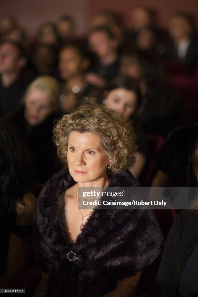 Serious woman in theater audience