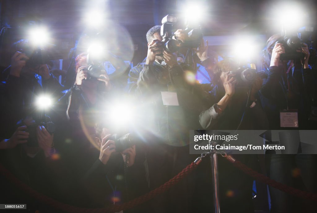 Paparazzi using flash photography at red carpet event