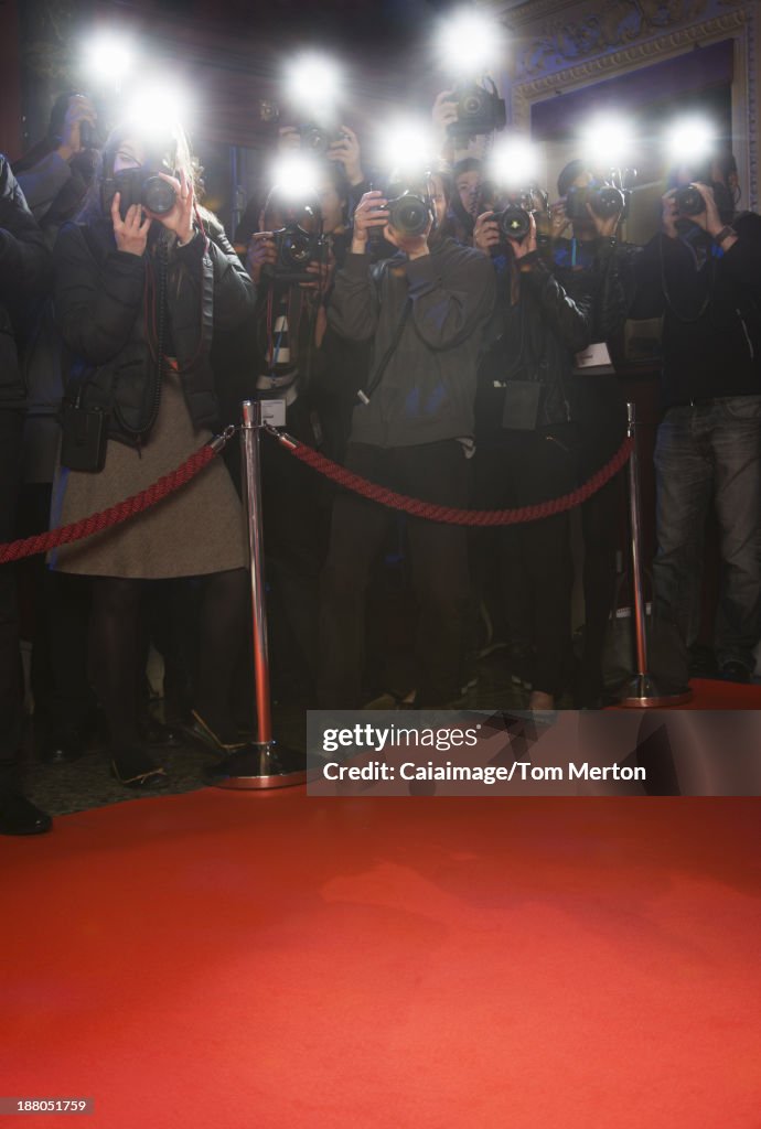 Paparazzi using flash photography at red carpet event