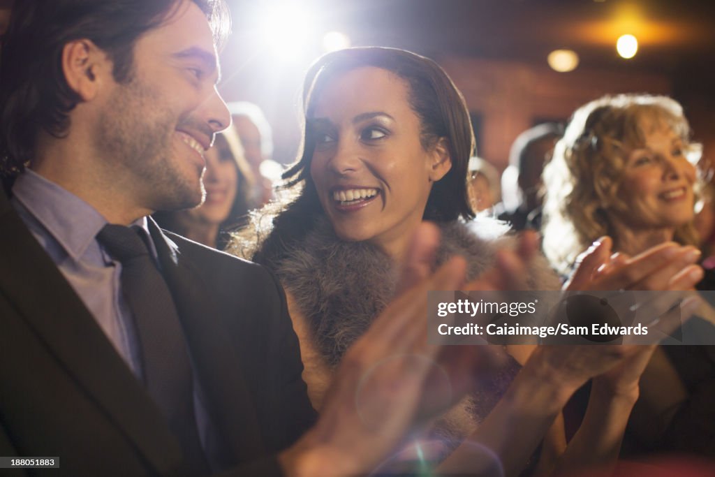 Close up of couple clapping in theater