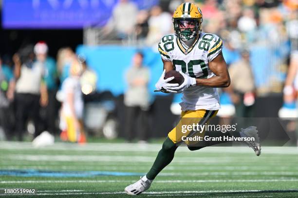 Bo Melton of the Green Bay Packers carries the ball during the first quarter against the Carolina Panthers at Bank of America Stadium on December 24,...