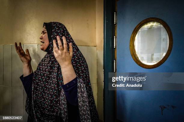 Woman cries as relatives of the Palestinians died in Israeli attacks mourn as bodies of those killed in the attacks were brought to the morgue of...