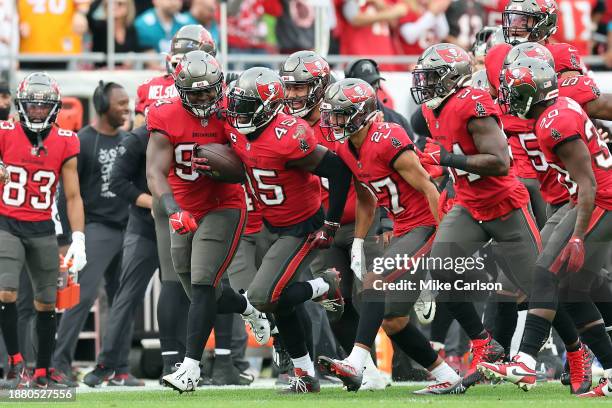 Devin White of the Tampa Bay Buccaneers celebrates with teammates after an interception against the Jacksonville Jaguars during the first quarter at...