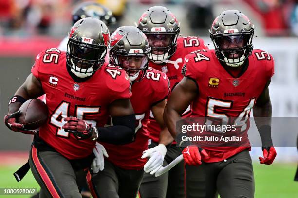 Devin White of the Tampa Bay Buccaneers celebrates with teammates after an interception against the Jacksonville Jaguars during the first quarter at...
