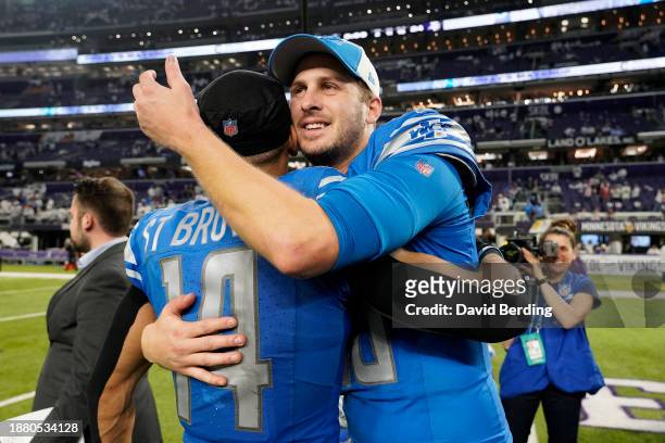 Jared Goff and Amon-Ra St. Brown of the Detroit Lions celebrate the 30-24 win against the Minnesota Vikings at U.S. Bank Stadium on December 24, 2023...