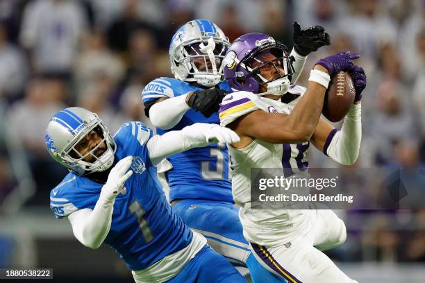 Justin Jefferson of the Minnesota Vikings catches a pass against Cameron Sutton and Kerby Joseph of the Detroit Lions during the fourth quarter at...