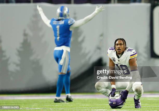 Justin Jefferson of the Minnesota Vikings reacts after a Detroit Lions interception at the end of the fourth quarter as Cameron Sutton celebrates at...