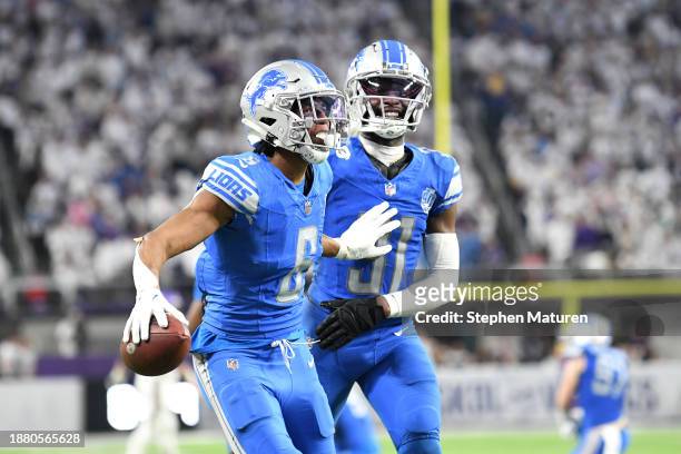 Ifeatu Melifonwu of the Detroit Lions is congratulated by Kerby Joseph after an interception against the Minnesota Vikings at the end of the fourth...