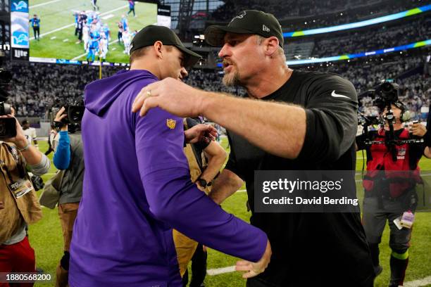 Head coach Kevin O'Connell of the Minnesota Vikings and head coach Dan Campbell of the Detroit Lions meet at mid-field following the Lions 30-24 win...