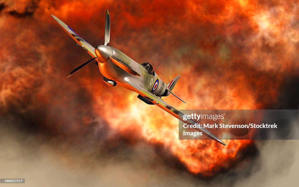 A British Supermarine Spitfire bursting through the explosive flames of its recent kill.