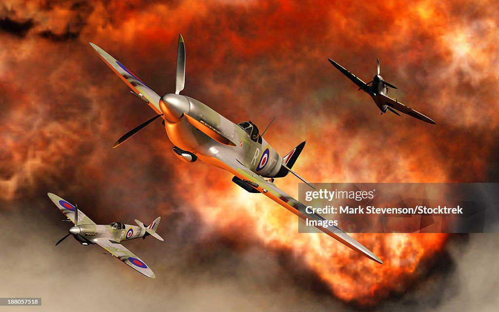 British Supermarine Spitfires bursting through the explosive flames of their recent kill.