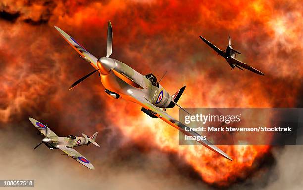british supermarine spitfires bursting through the explosive flames of their recent kill. - battle of britain stock illustrations