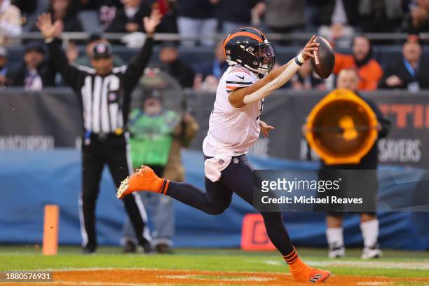 Justin Fields of the Chicago Bears scrambles to score a touchdown during the first quarter against the Arizona Cardinals at Soldier Field on December...