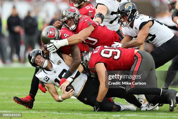 Trevor Lawrence of the Jacksonville Jaguars is sacked by Lavonte David of the Tampa Bay Buccaneers during the second quarter at Raymond James Stadium...