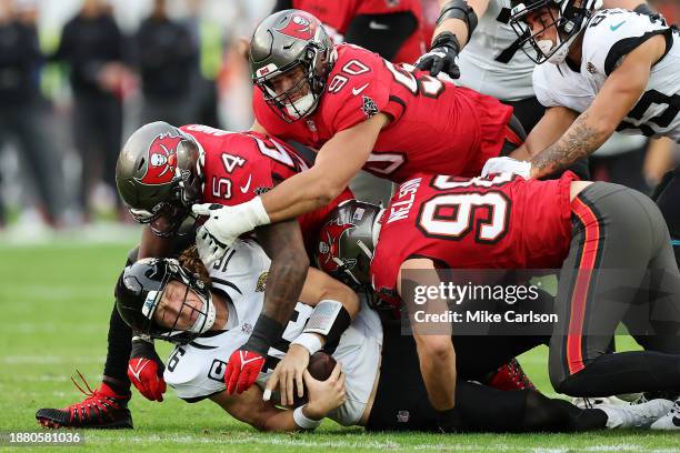 Trevor Lawrence of the Jacksonville Jaguars is sacked by Lavonte David of the Tampa Bay Buccaneers during the second quarter at Raymond James Stadium...
