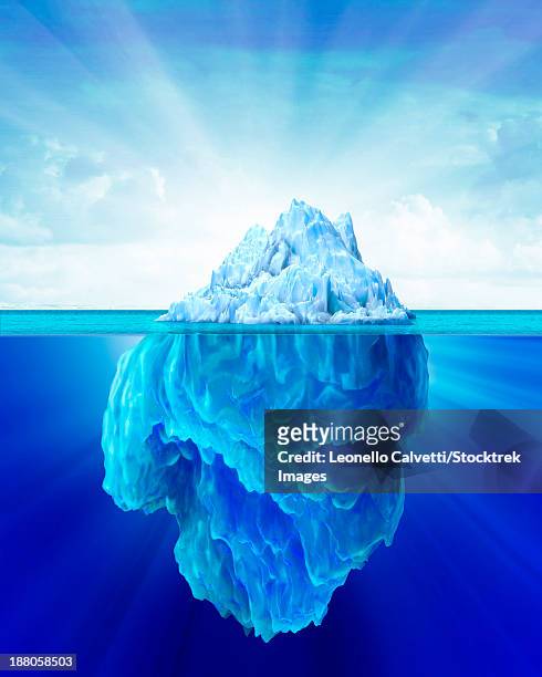 solitary iceberg in the sea with a soft cloudy sky in the background. - iceberg above and below water stock illustrations