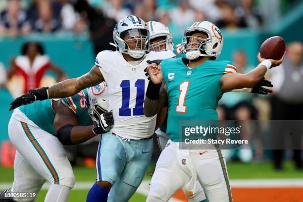 Tua Tagovailoa of the Miami Dolphins throws a pass while pressured by Micah Parsons of the Dallas Cowboys during the first quarter at Hard Rock...