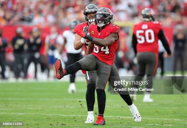 Lavonte David of the Tampa Bay Buccaneers is congratulated by Logan Hall after a sack against the Jacksonville Jaguars during the second quarter at...