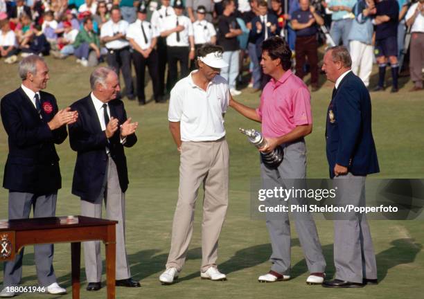 Ian Baker-Finch of Australia receives the trophy and stands beside Mike Harwood of Australia who finished second place, after winning the British...