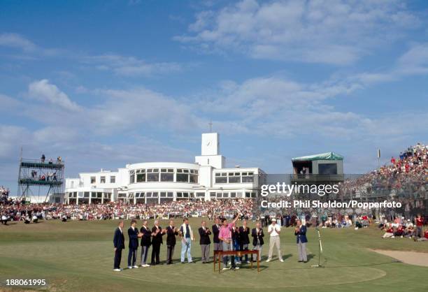 Ian Baker-Finch of Australia holds the trophy, as Mike Harwood ofAustralia looks on, after winning the British Open Golf Championship held at the...