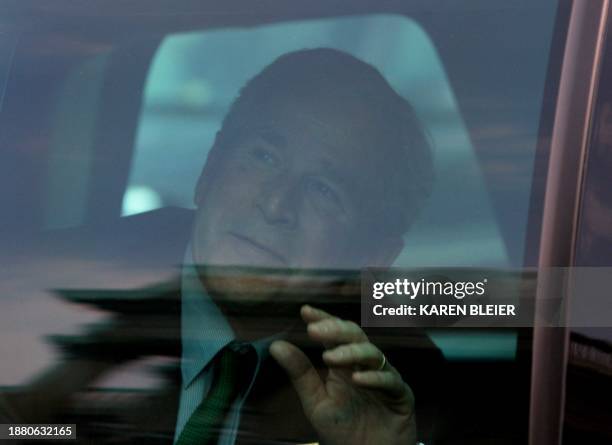 President George W. Bush waves from his limousine as he departs the Capitol following a St Patrick's Day luncheon with Irish Prime Minister Bertie...