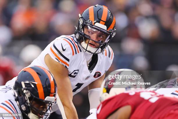 Justin Fields of the Chicago Bears calls a play during the first quarter against the Arizona Cardinals at Soldier Field on December 24, 2023 in...