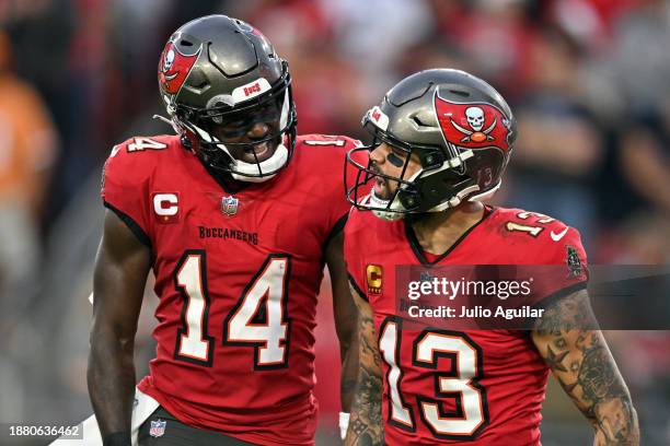 Mike Evans of the Tampa Bay Buccaneers is congratulated by Chris Godwin after scoring a touchdown reception against the Jacksonville Jaguars during...