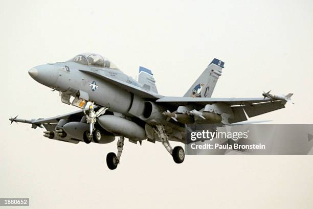 Navy F-18 comes in for a landing after being diverted from its aircraft carrier March 27, 2003 on an air base in Kuwait. Flights were delayed in the...