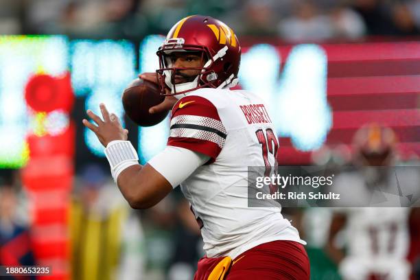 Jacoby Brissett of the Washington Commanders looks to pass during the second half against the New York Jets at MetLife Stadium on December 24, 2023...