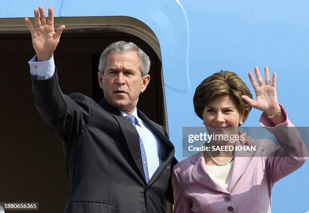 President George W.Bush and First lady Laura wave upon arriving at Hanoi international airport, 17 November 2006. President Bush arrived to attend a...