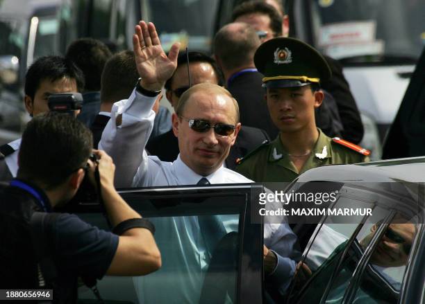 Russian President Vladimir Putin waves upon his arrival to Hanoi international airport, 18 November 2006. Putin arrived to attend the Asia Pacific...