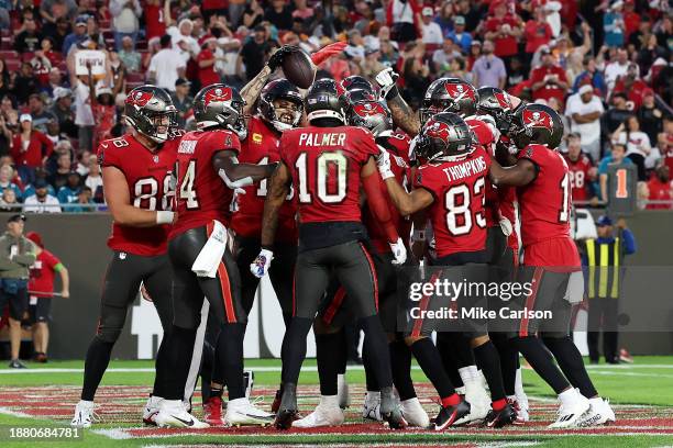 Rachaad White of the Tampa Bay Buccaneers is congratulated by his teammates after scoring a rushing touchdown against the Jacksonville Jaguars at...