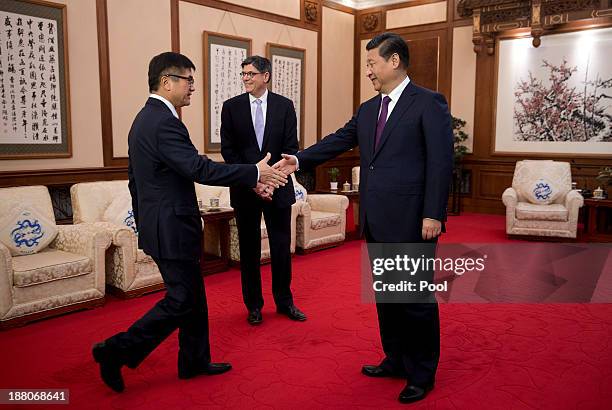 Treasury Secretary Jack Lew looks on as President Xi Jinping shakes hands with U.S Ambassador to China Gary Locke before their meeting at the...