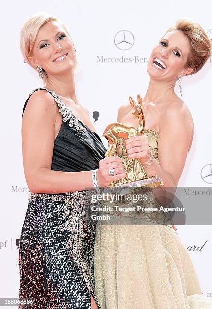 Mareille Hoeppner and Kamilla Senjo pose with the people choice Bambi at Stage Theater on November 14, 2013 in Berlin, Germany.