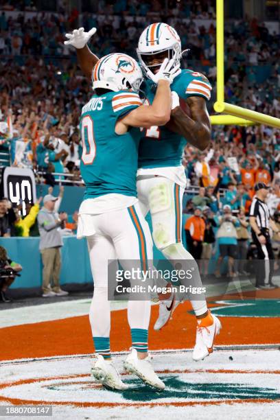 Raheem Mostert of the Miami Dolphins celebrates after a touchdown with Braxton Berrios during the second quarter in the game against the Dallas...