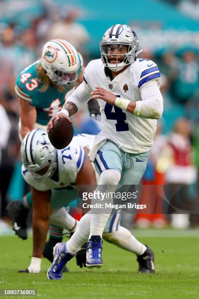 Dak Prescott of the Dallas Cowboys scrambles during the first half in the game against the Miami Dolphins at Hard Rock Stadium on December 24, 2023...