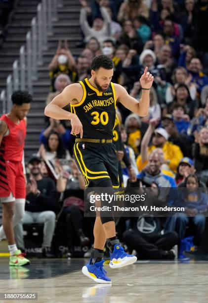 Stephen Curry of the Golden State Warriors reacts after scoring and being fouled on the shot against the Portland Trail Blazers during the first half...