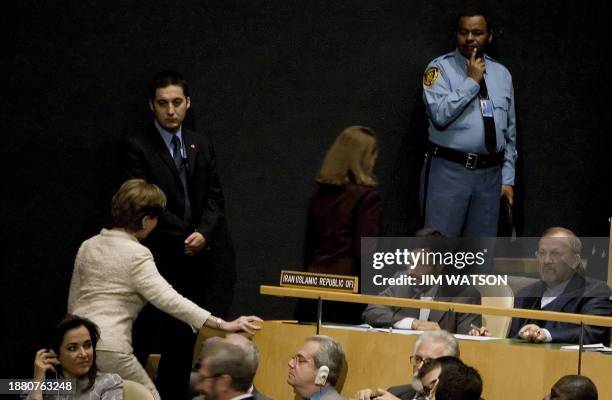 First Lady Laura Bush walks past Iranian President Mahmoud Ahmadinejad as she takes her seat for US President George W. Bush's address to the United...