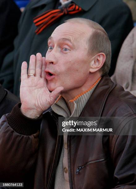 Russian President Vladimir Putin shouts "Happy holiday!" during a concert at the Red Square in Moscow, 09 May 2007, during the annual celebration of...