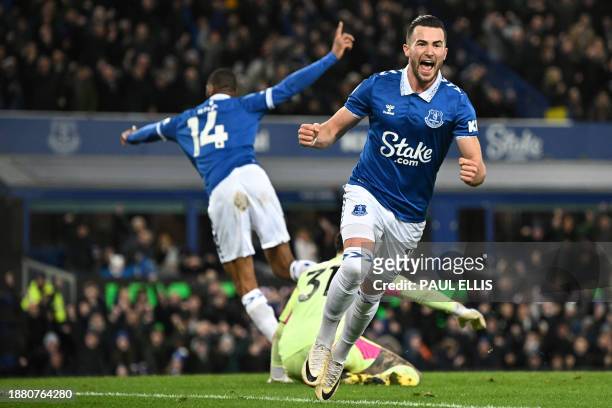 Everton's English striker Jack Harrison celebrates after scoring his team first goal during the English Premier League football match between Everton...