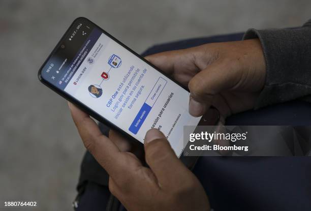 Migrant uses the CBP One application during an Al Otro Lado training session in Tijuana, Mexico, on Tuesday, Nov. 28 2023. President Biden has argued...