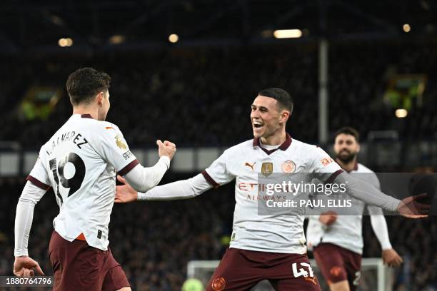 Manchester City's Argentinian striker Julian Alvarez celebrates with Manchester City's English midfielder Phil Foden after scoring his team second...