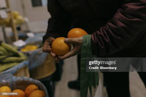 Guest picks oranges at the Neighbor to Neighbor food pantry in Greenwich, Connecticut, US, on Monday, Nov. 20, 2023. Neighbor to Neighbor is one of...