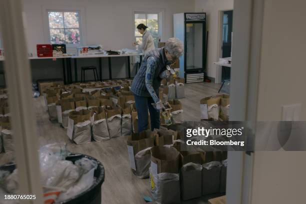Volunteer organizes bags of groceries at the Neighbor to Neighbor food pantry in Greenwich, Connecticut, US, on Monday, Nov. 20, 2023. Neighbor to...
