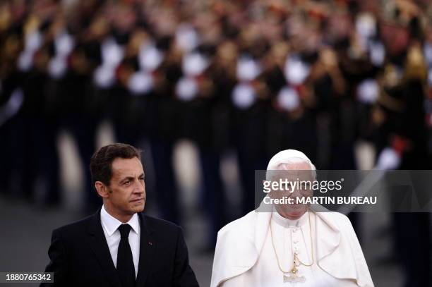 Pope Benedict XVI is accompanied by French President Nicolas Sarkozy upon arrival at Orly airport, south of Paris, on September 12, 2008 for his...