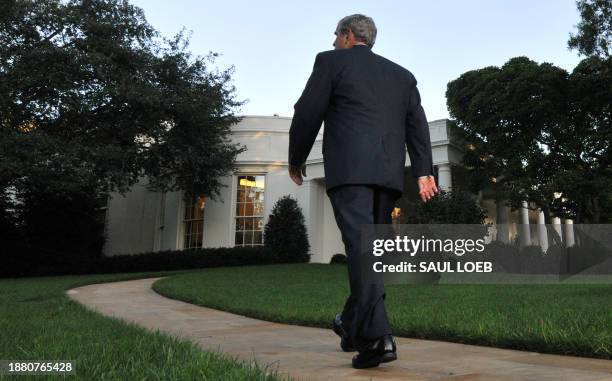 President George W. Bush walks back to the Oval Office after speaking regarding the financial rescue legislation on the South Lawn of the White House...