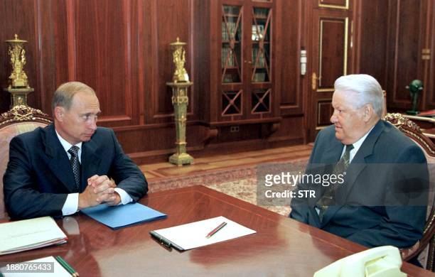 Security Council Secretary Vladimir Putin listens to Russian President Boris Yeltsin during their meeting in Moscow's Kremlin, 27 July 1999. Russian...