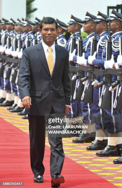 Maldivian Democratic Party founder and newly sworn in President Mohamed 'Anni' Nasheed inspects a Maldives National Defence Force Honour Guard in a...